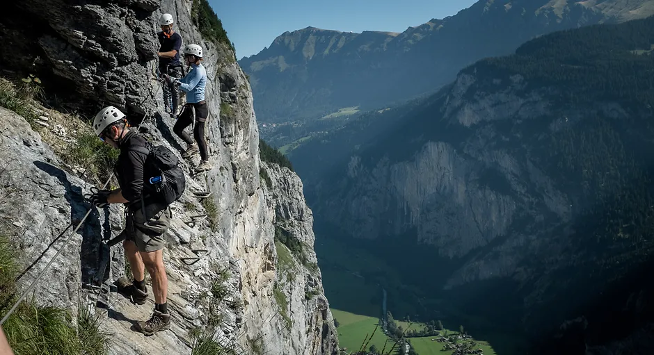 Group on the via ferrata of the Tschirpen ridge above Arosa, clipped to the fixed steel cable.