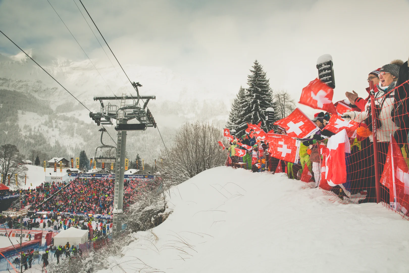 Spectators waving Swiss flags on the Girmschbiel slope during the Lauberhorn downhill