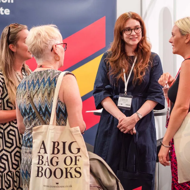 Ladies talking on exhibition stand