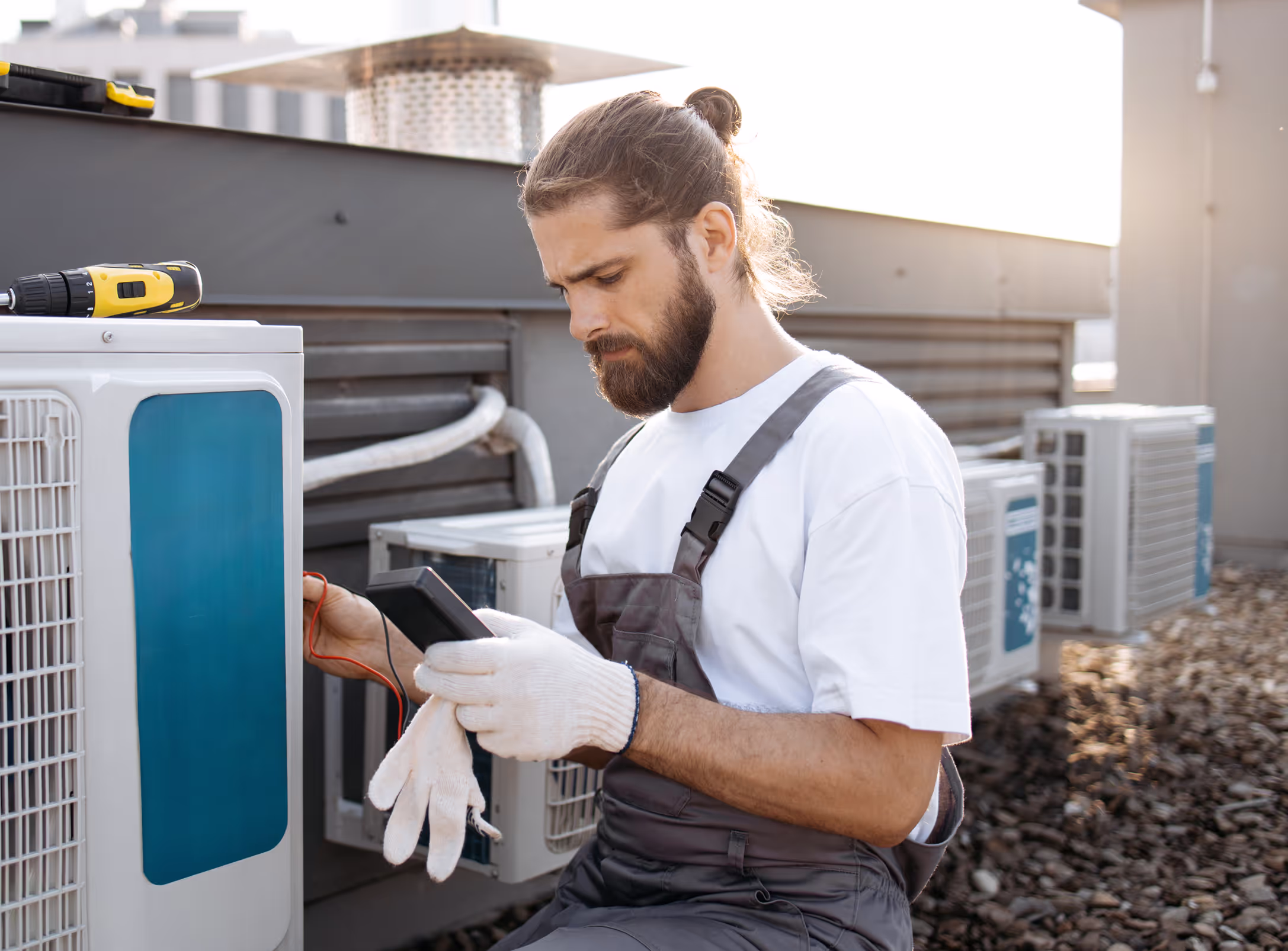 Technician running diagnostics on an HVAC unit.