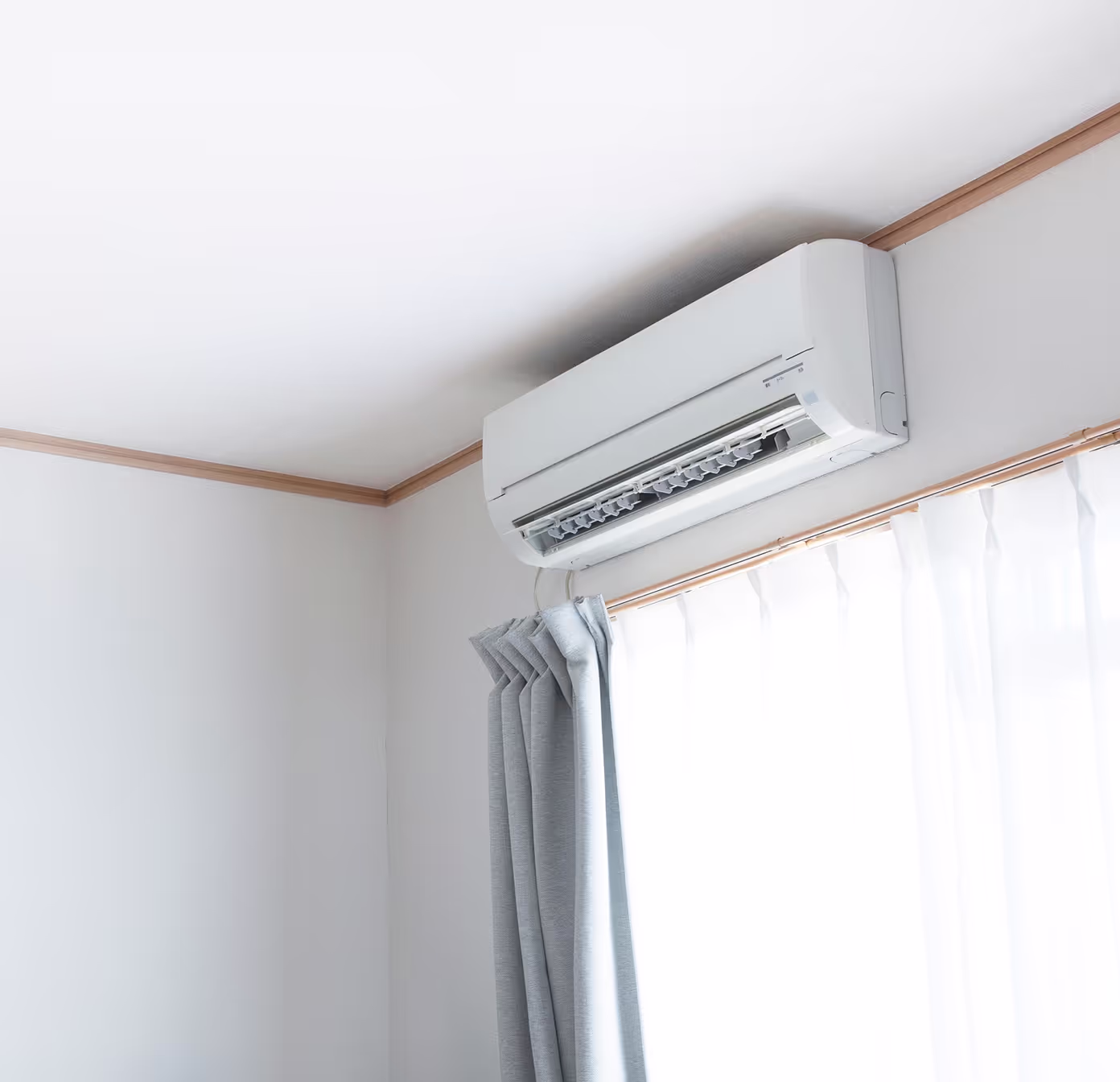 Split AC unit mounted on the wall inside a room.