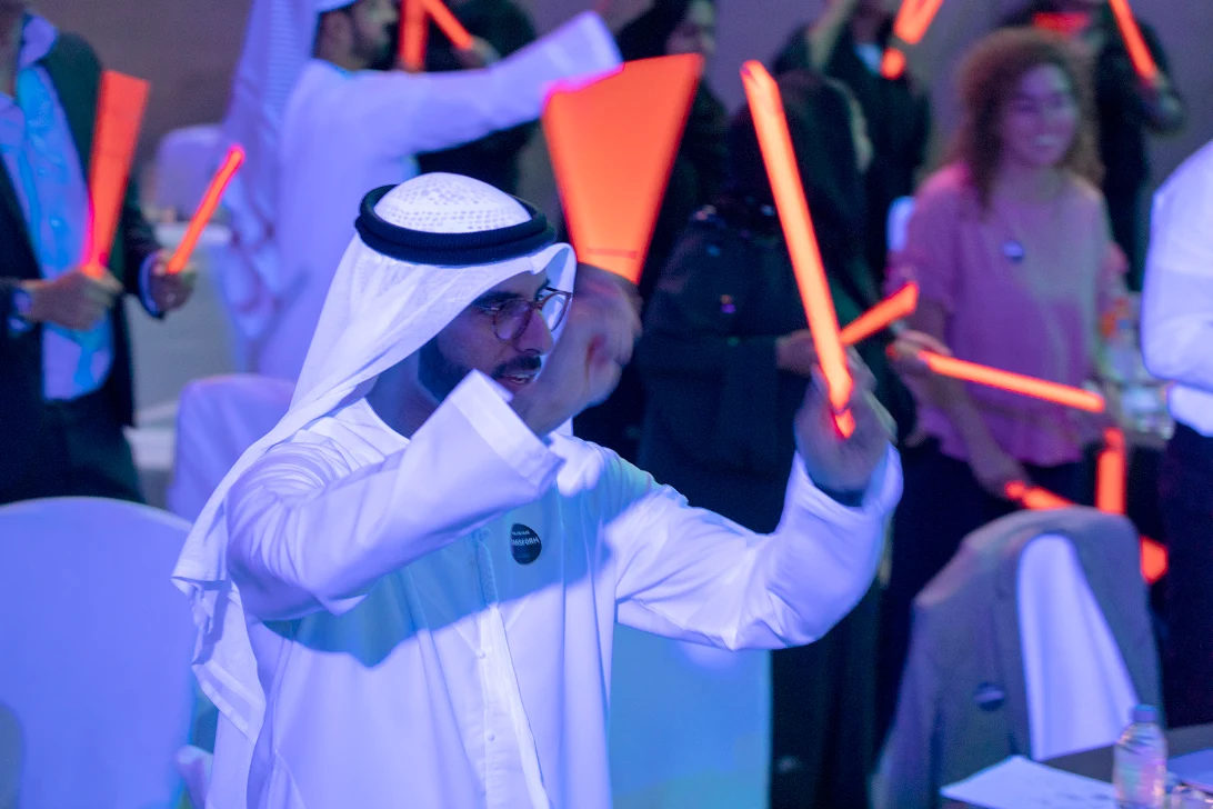 Guests celebrating with light sticks at a launch