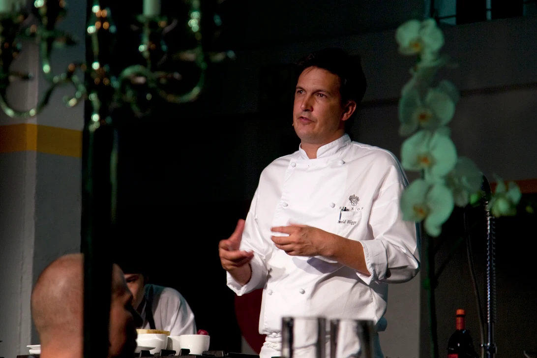 Chef speaking to guests in low light
