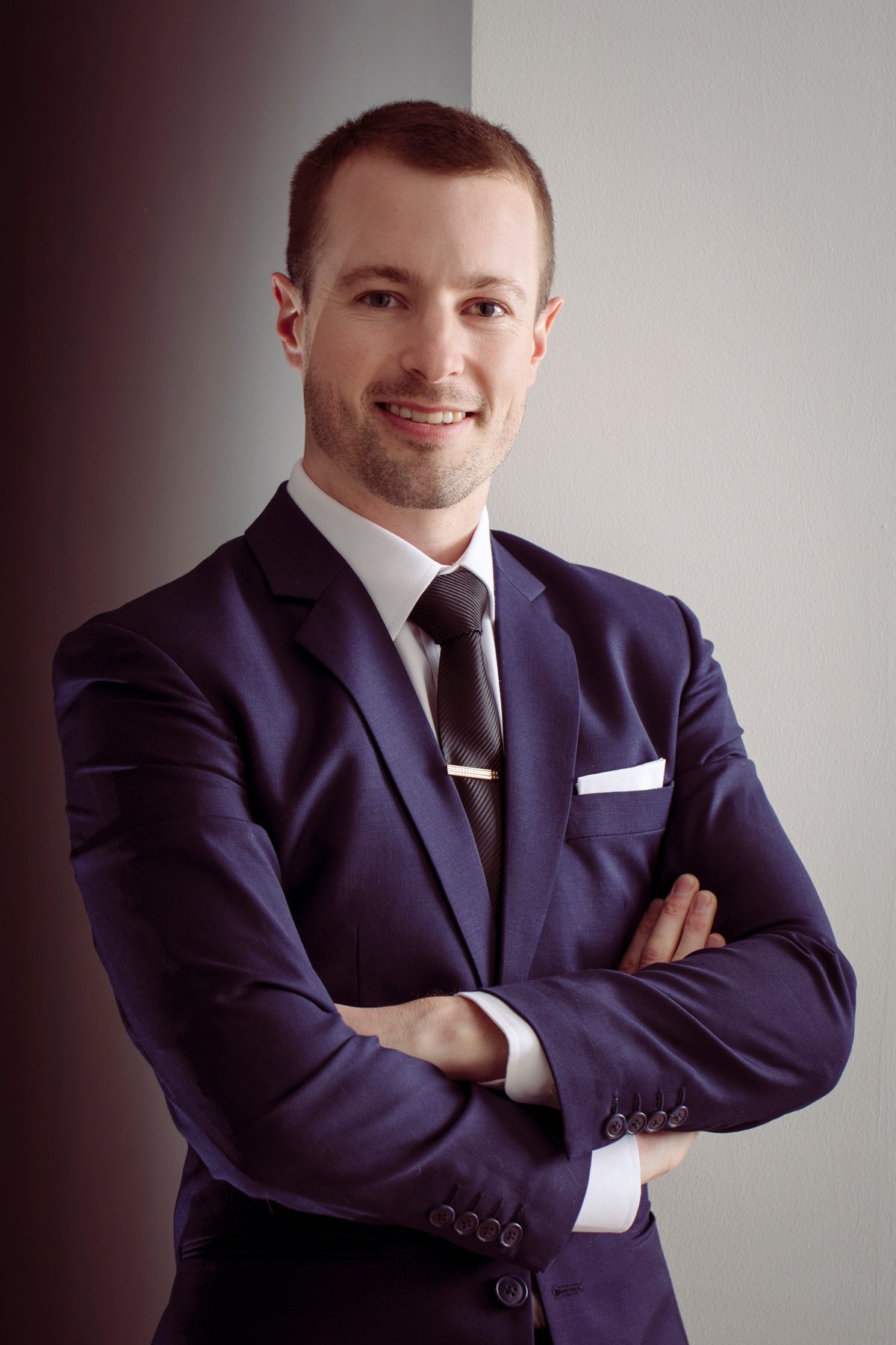 Man in a tailored suit, arms folded