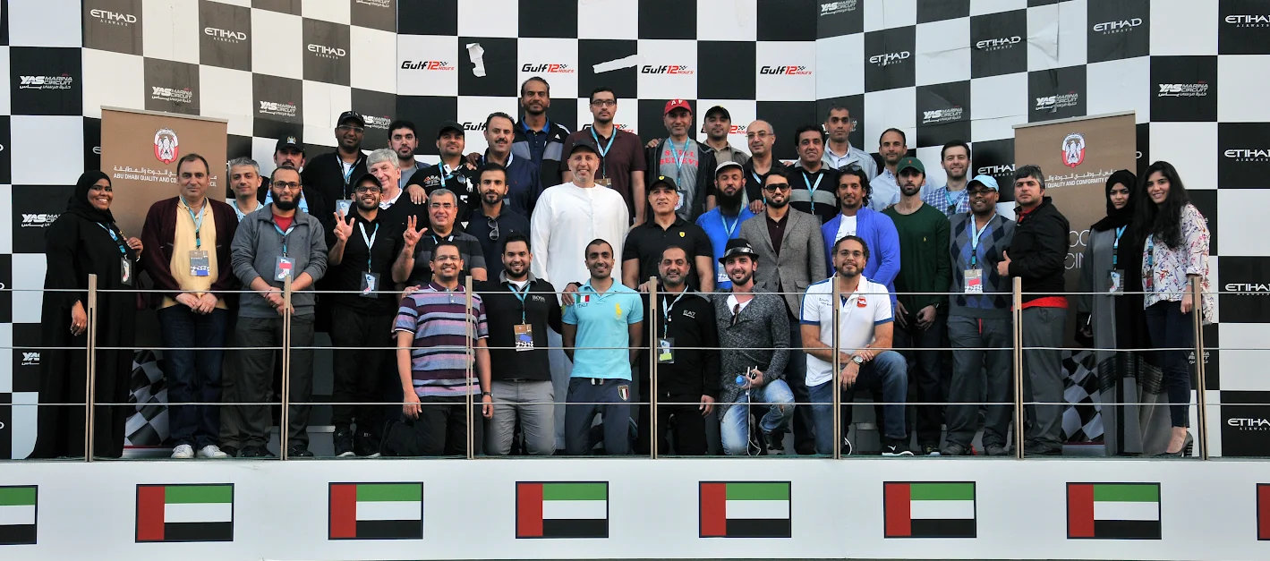 Large group photo in a race circuit grandstand