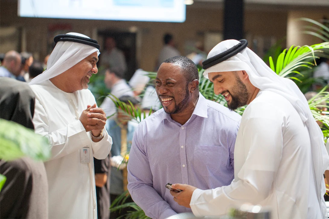 Colleagues sharing a laugh at an office celebration