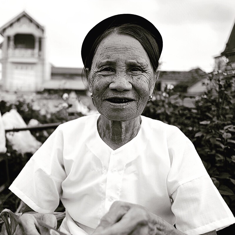 Black and white portrait of a smiling older woman