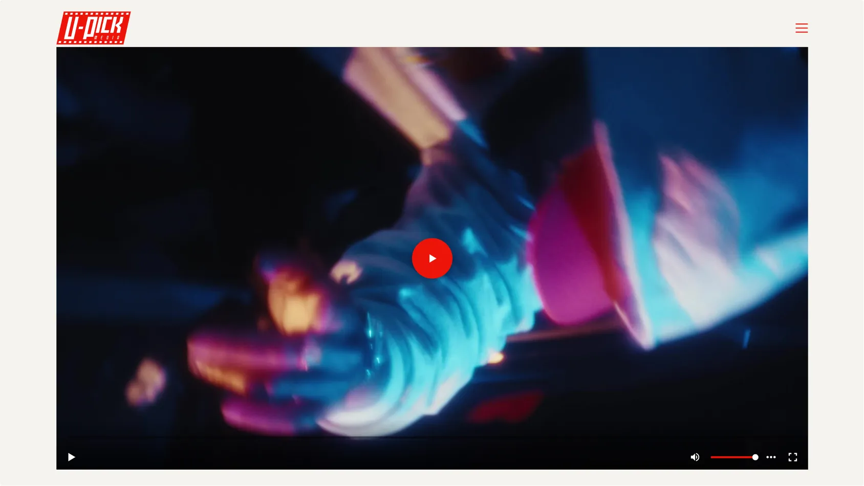 Blurred close-up of a person wearing a light-colored jacket and holding a red cup under blue and purple lighting.