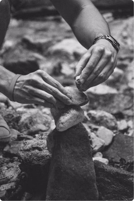 A person balancing rocks on top of each other