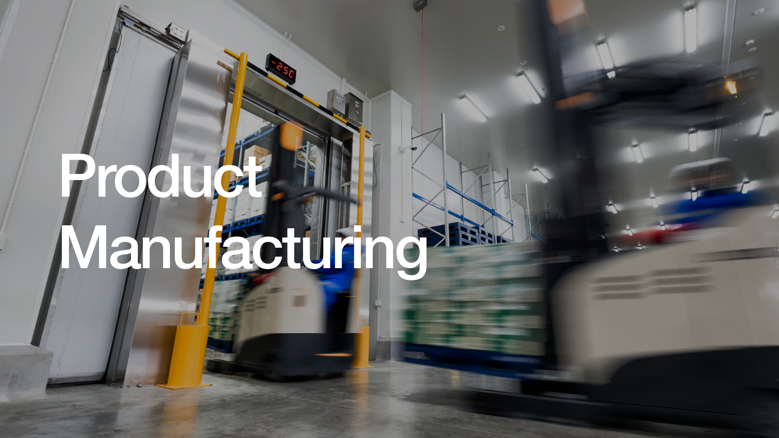 Motion-blurred forklifts transporting pallets inside a cold storage warehouse with a temperature display showing -25°C.