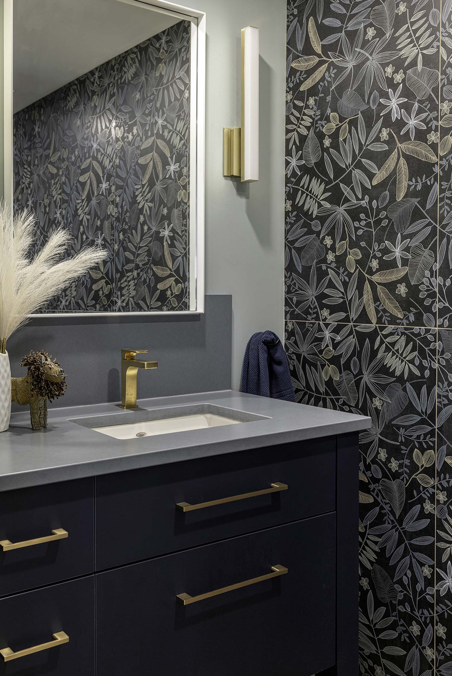 Powder room featuring a unique, bold, but subtle wallpaper.