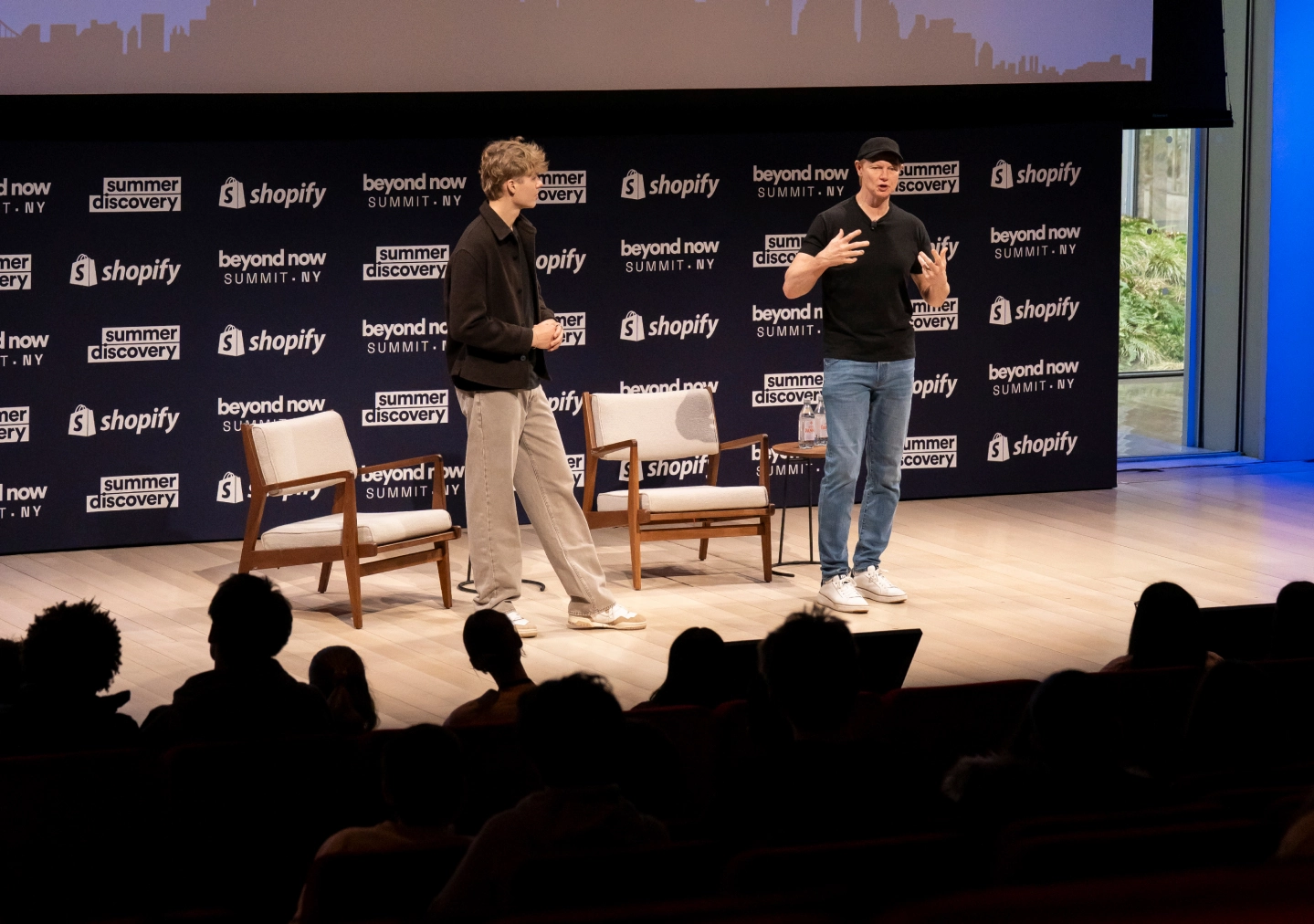 Nighttime cityscape featuring the Empire State Building illuminated against a dark sky.