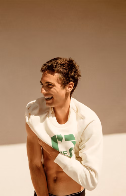 Diesel For Responsible Living: model in a white sweatshirt with a green logo