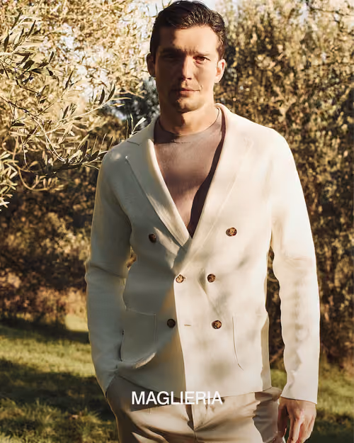 Paul Taylor: model in a cream double-breasted knit jacket outdoors