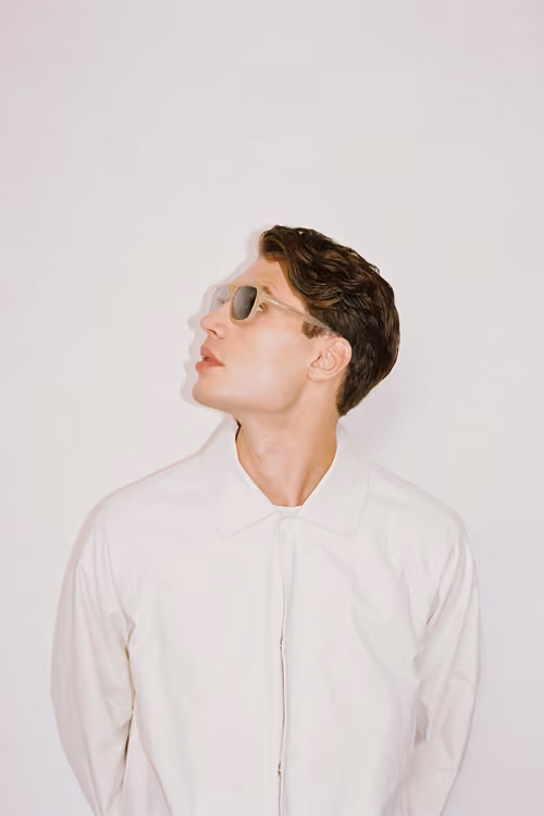 District People: model in a white shirt wearing sunglasses