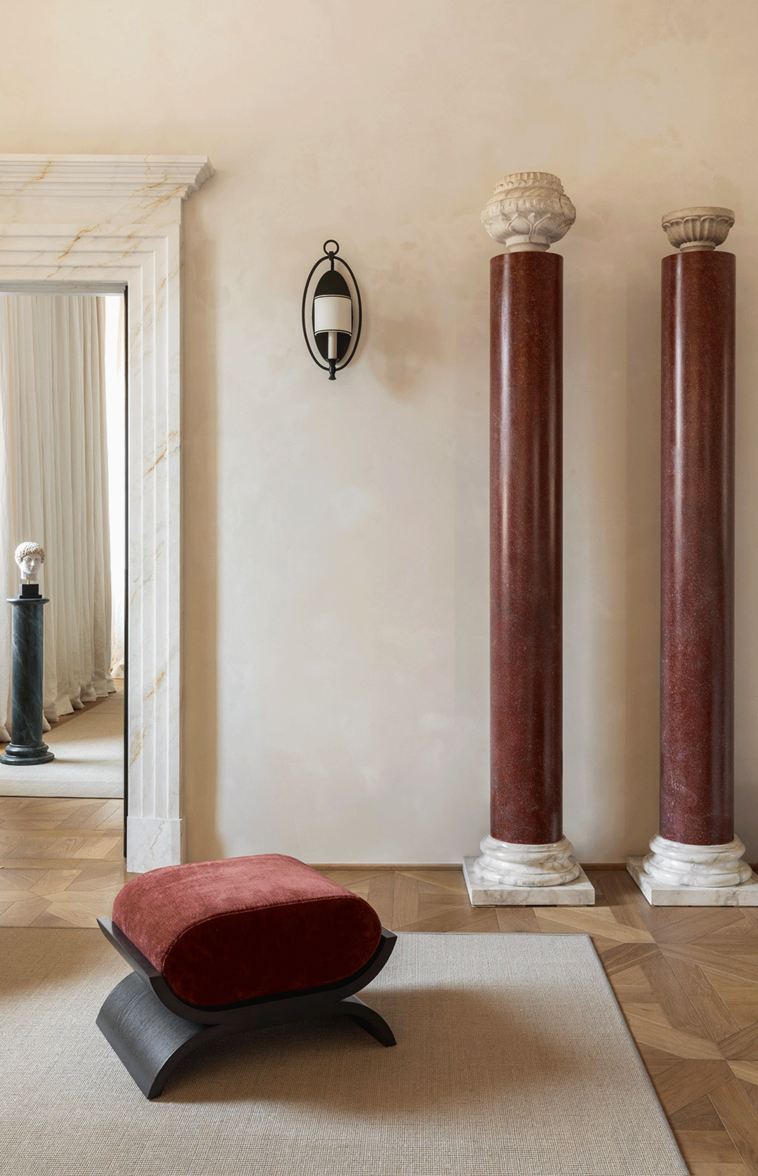 Casa Naman: red marble columns and a velvet stool