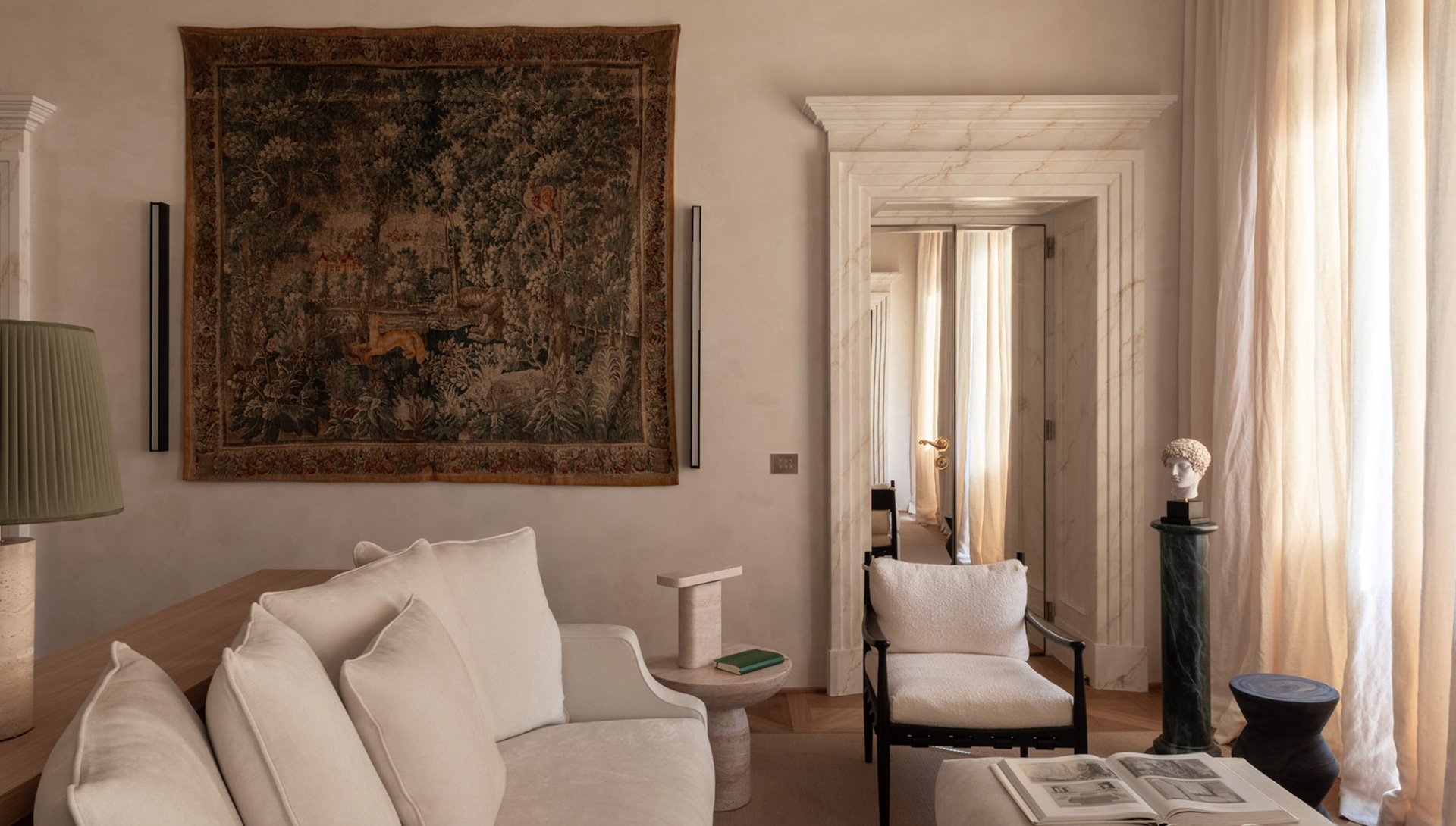 Casa Naman: living room with a tapestry, marble doorway and bust on a green column