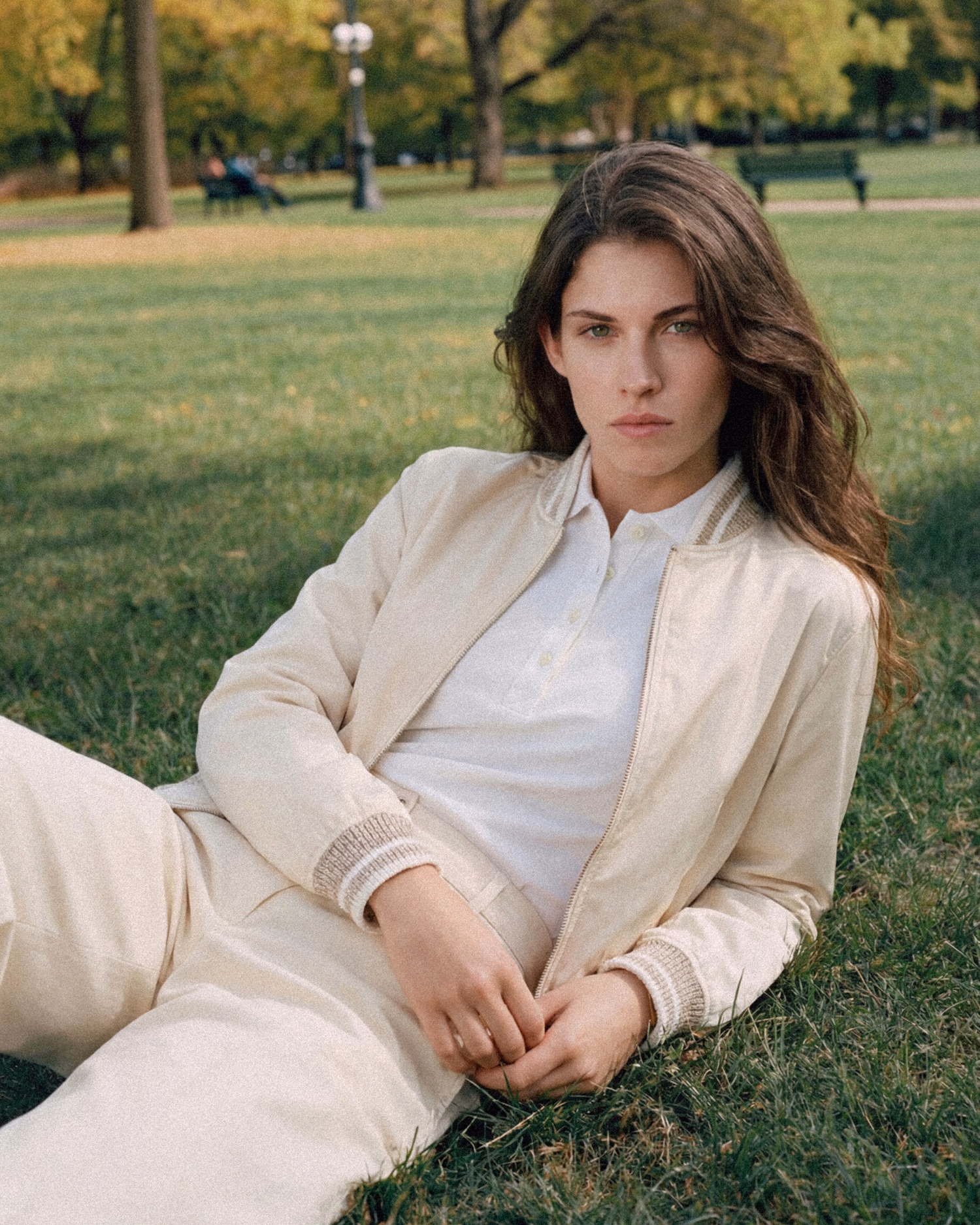 Paul & Shark FW26: woman in a cream jacket and trousers lying on the grass
