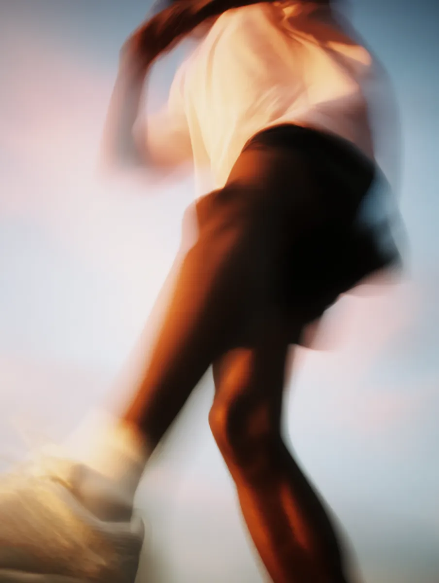AI-generated image of a motion-blurred figure running in warm light