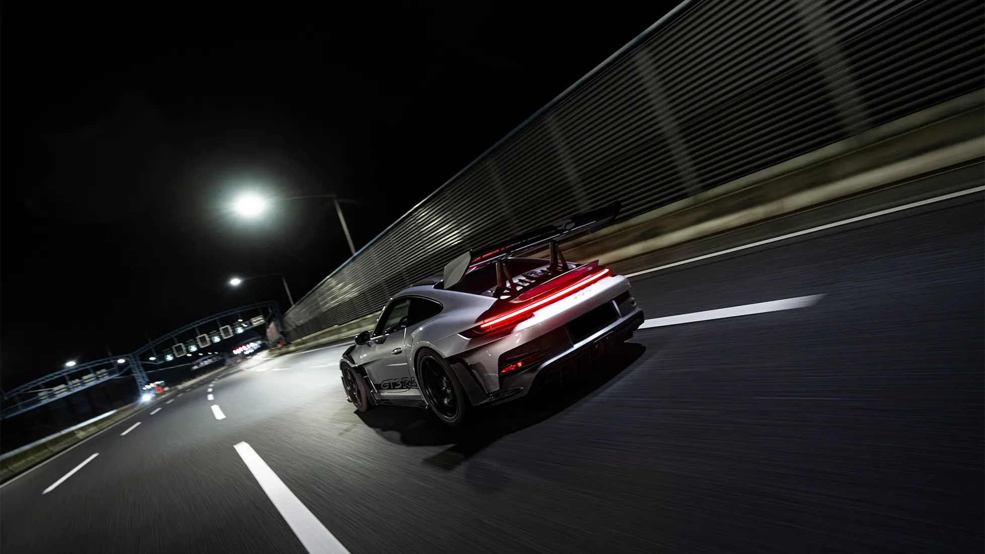 Silver Porsche 992 GT3 RS in a nighttime cityscape by MVO Productions