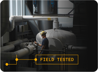 Worker checking vales on large machine assembly