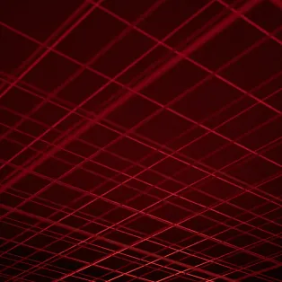 Líneas rojas brillantes formando un patrón de cuadrícula sobre fondo oscuro.