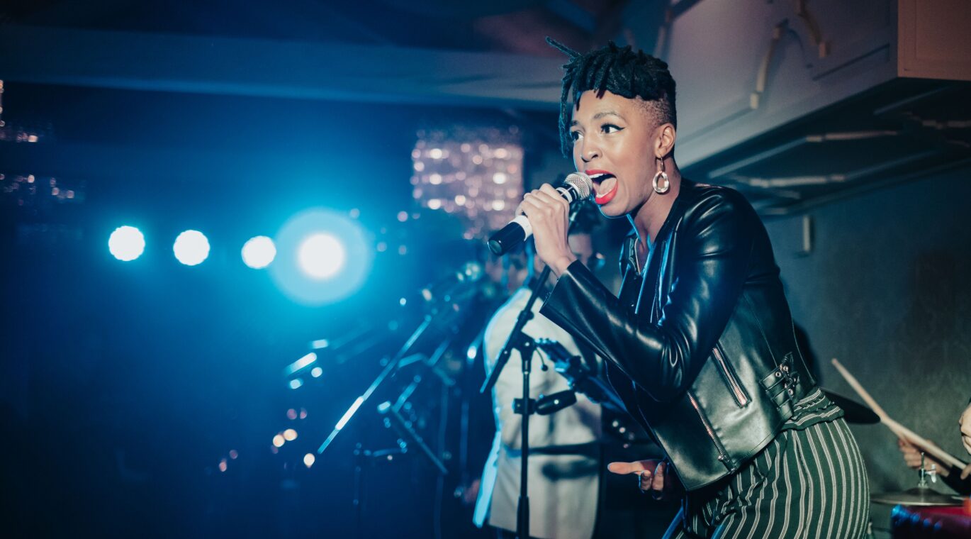 close up on singer on stage in a dark setting