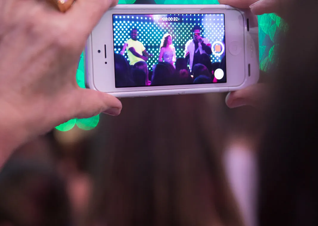 close up on person recording artists on stage