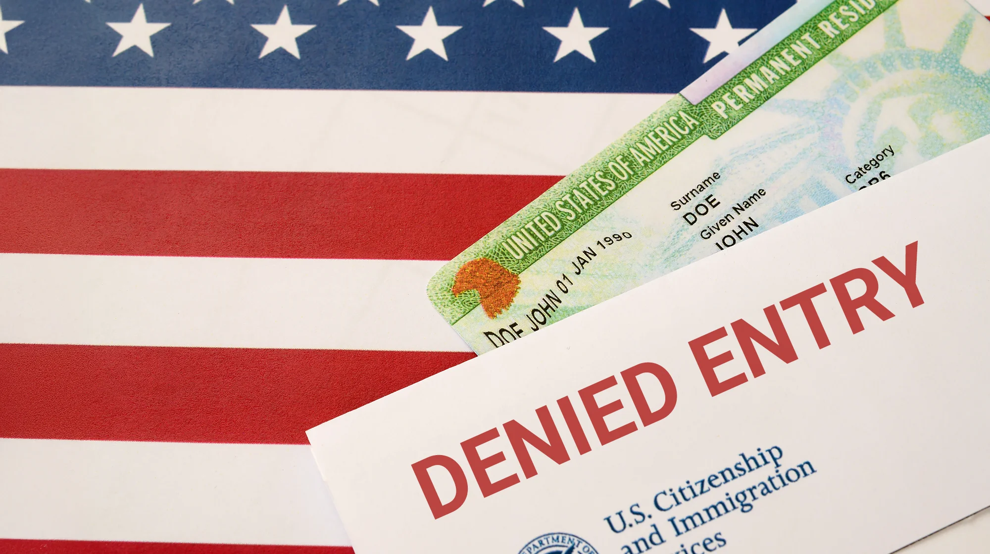 Illustration of a paper with inscription "Denied Entry" on top of green card and US Flag.
