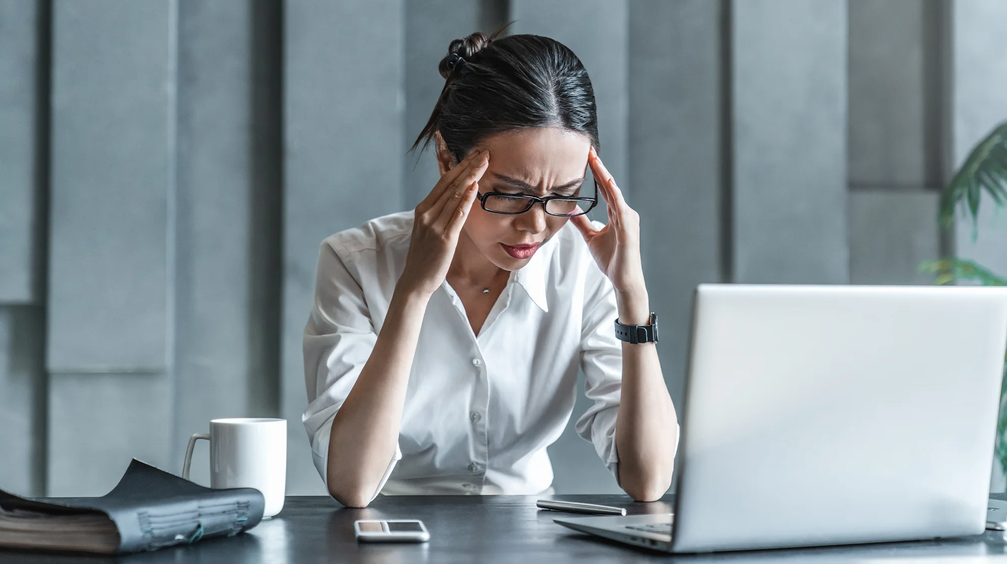 A woman in pain at her workplace.
