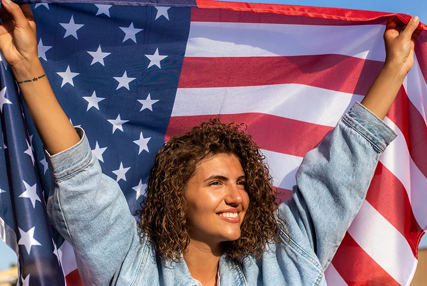 A woman holding US flag.