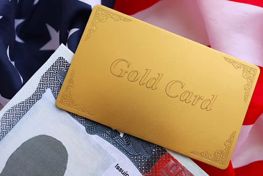 A Gold Card on a US visa and flag.