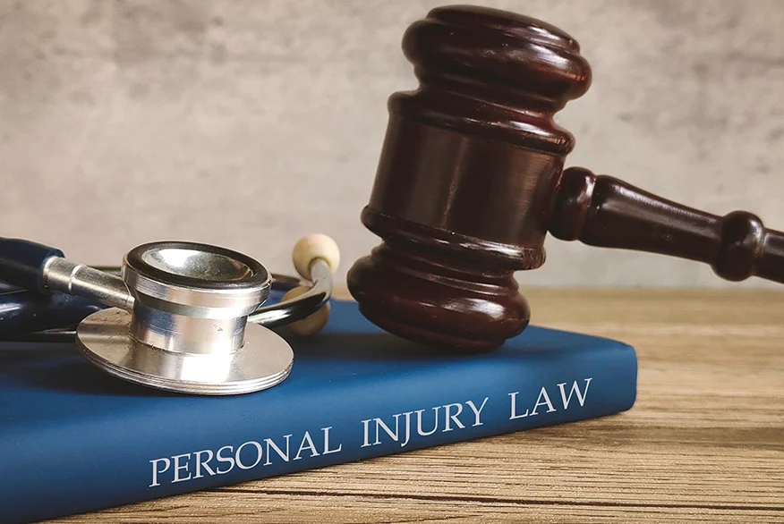 Gavel and stethoscope on a book titled "PERSONAL INJURY LAW," symbolizing legal action for medical issues.