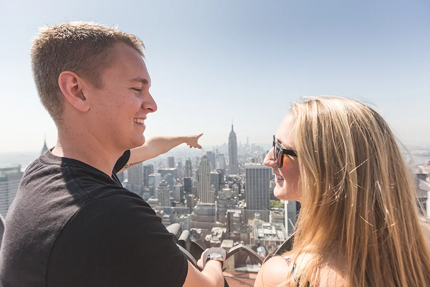 A happy young couple watching Empire State Building in NYC.