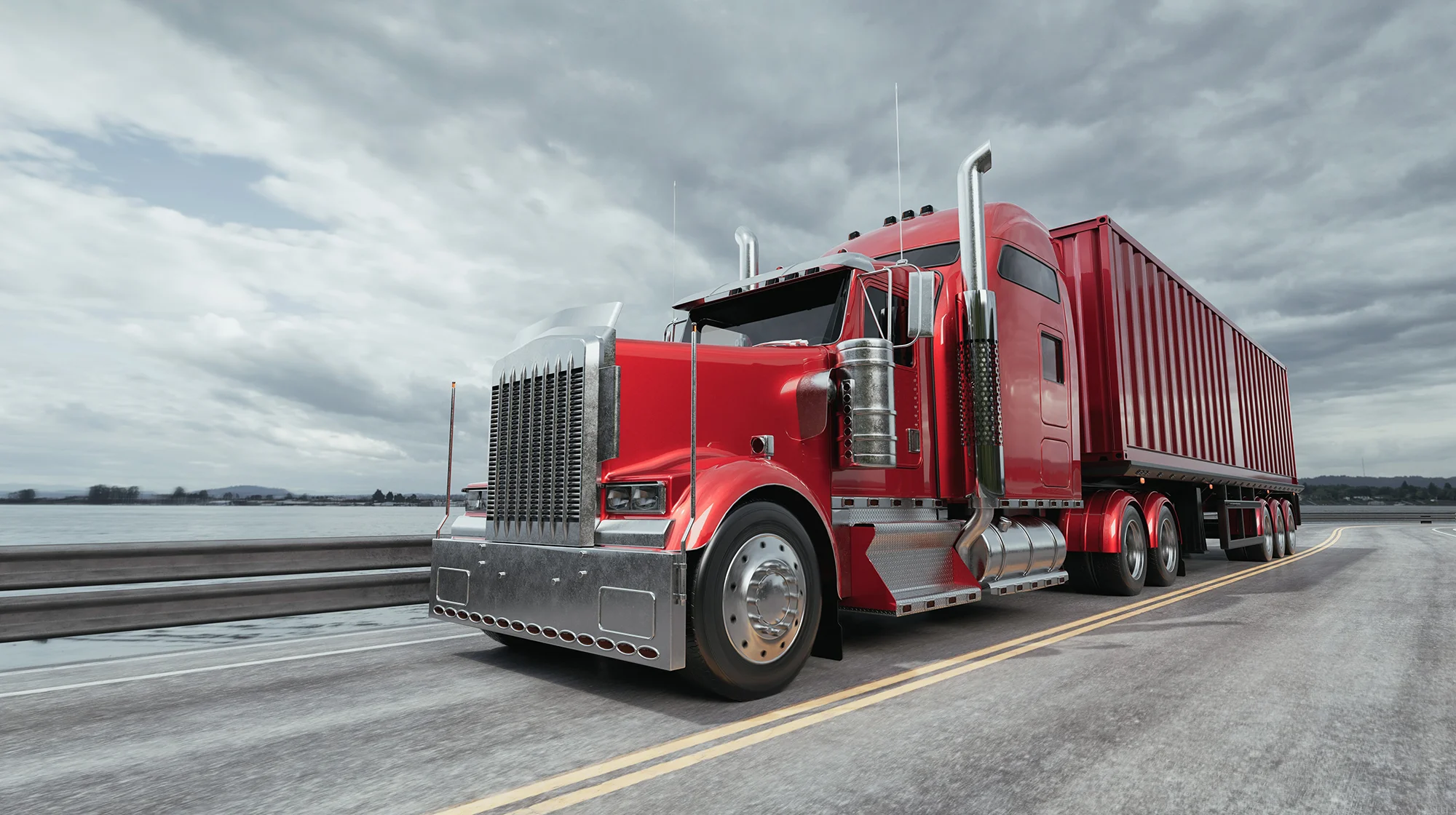 A red classic semi truck driving on the road.