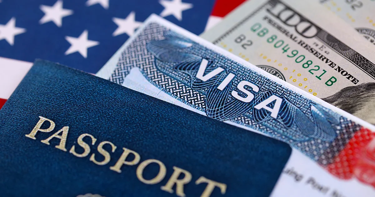 US Visa, Passport and dollars on a table.