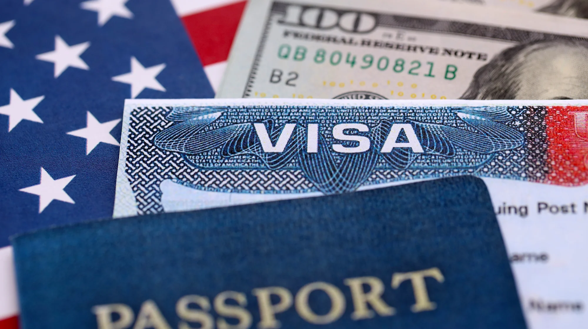 Close up picture of US Visa with dollars in the background.