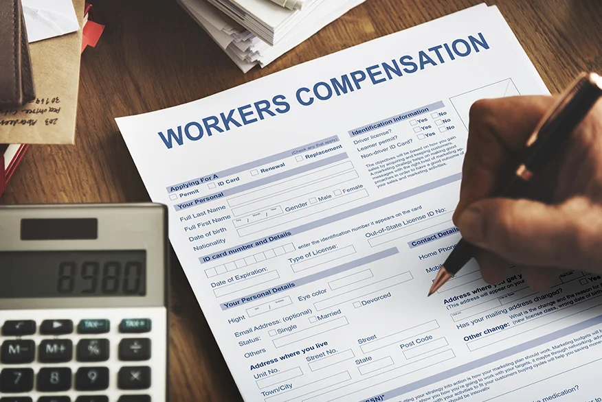 A "Workers Compensation" form on a table.