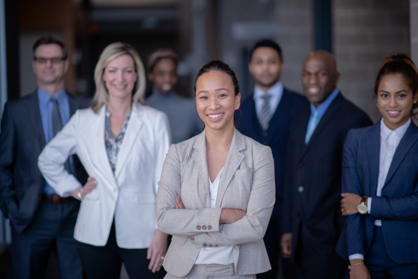 A diverse team of professionals standing together and smiling