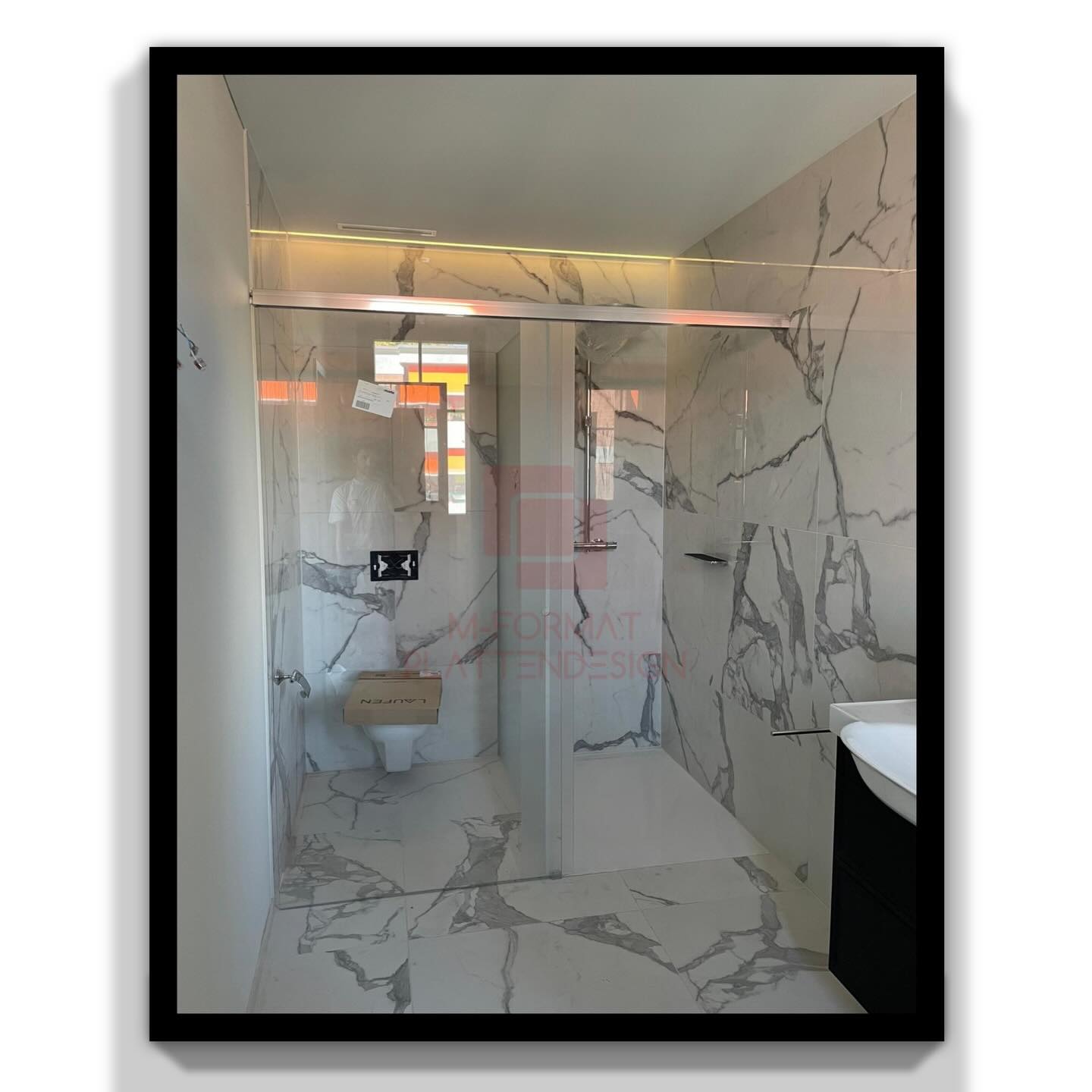 Durchgehende Wand- und Bodenplatten für eine moderne Dusche. Präzise Schnitte und perfekte Übergänge.