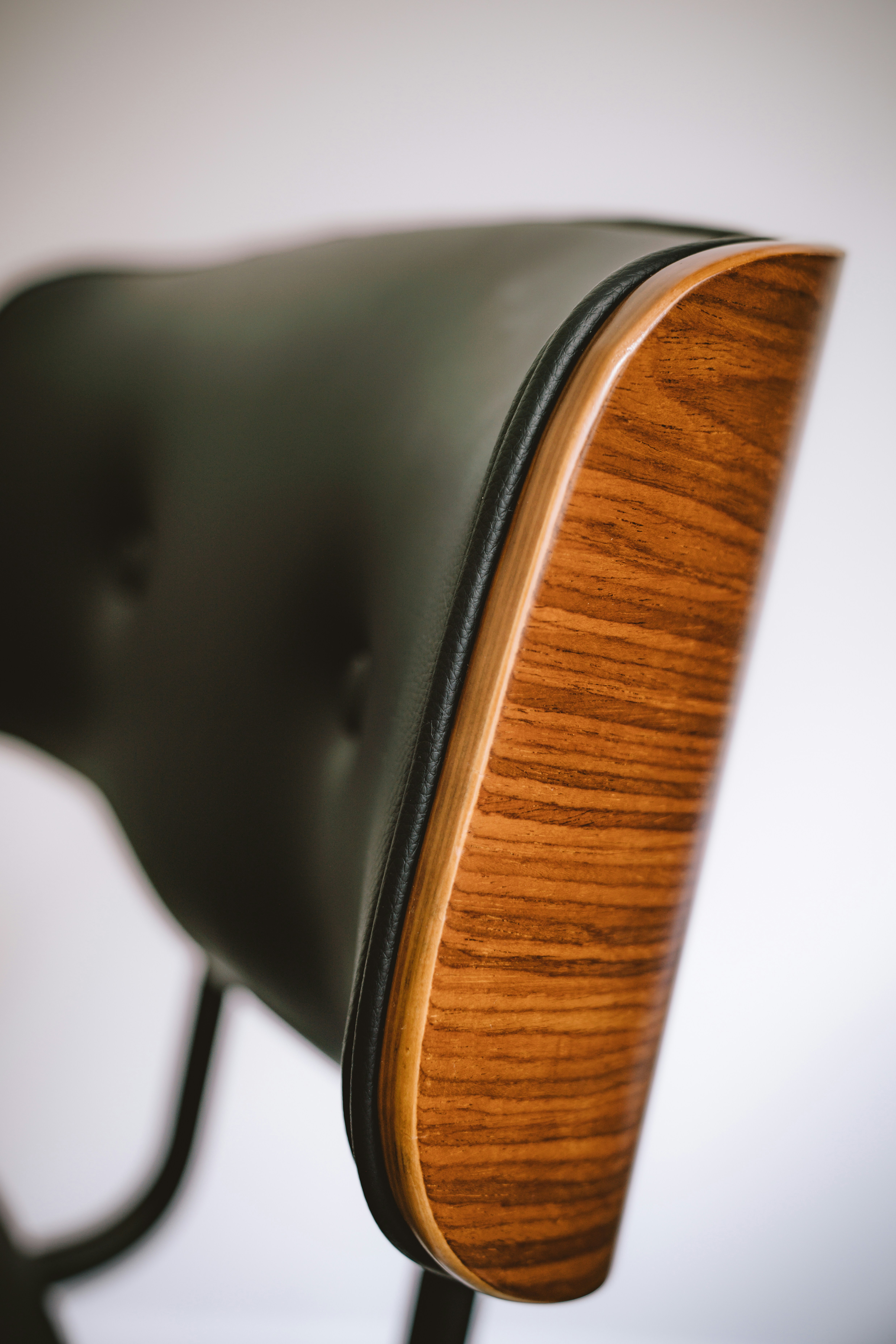 A wood and black leather elegant chair