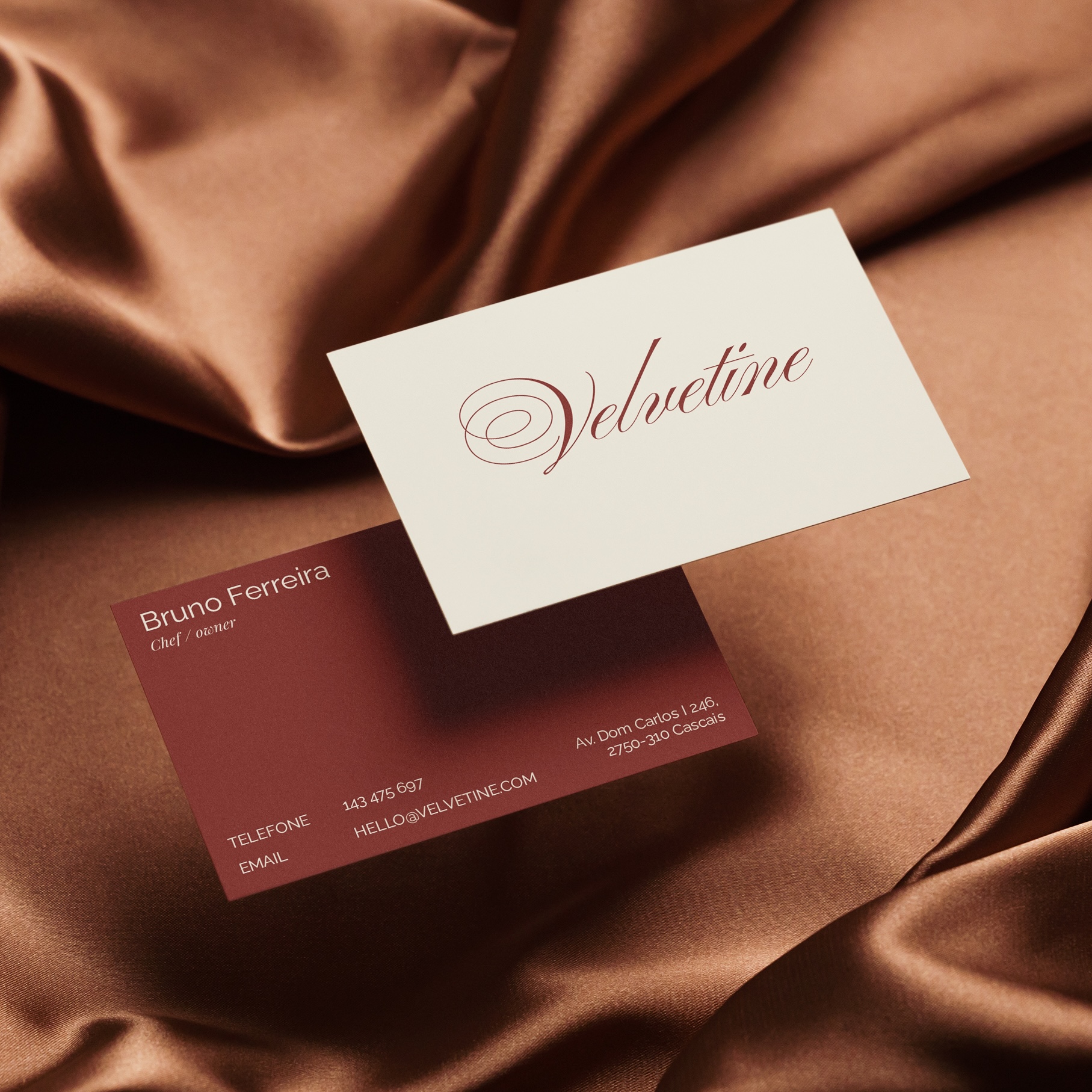 Velvetine business cards, above a satin fabric