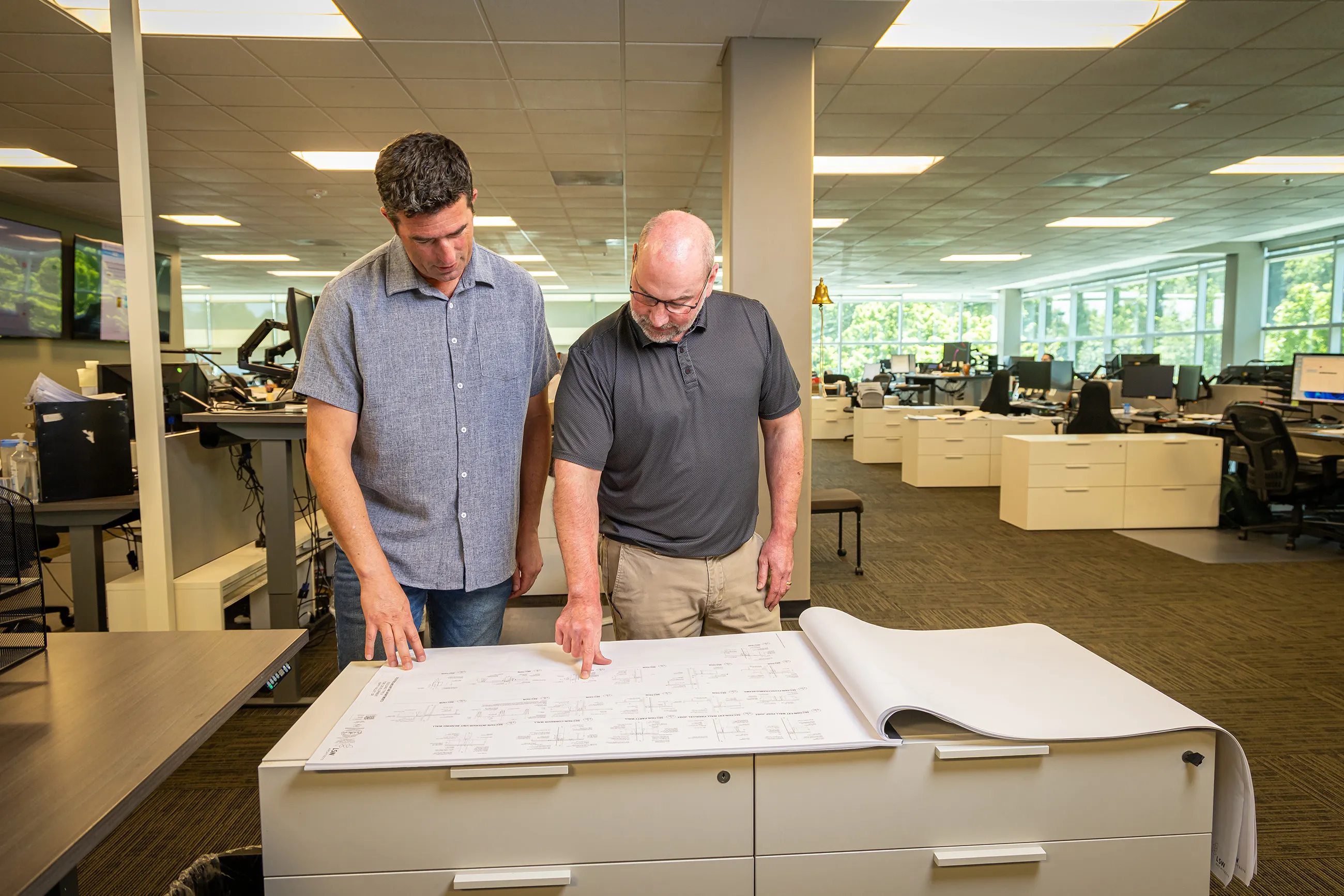 2 Shelter Products, Inc. employees reviewing plans in the office
