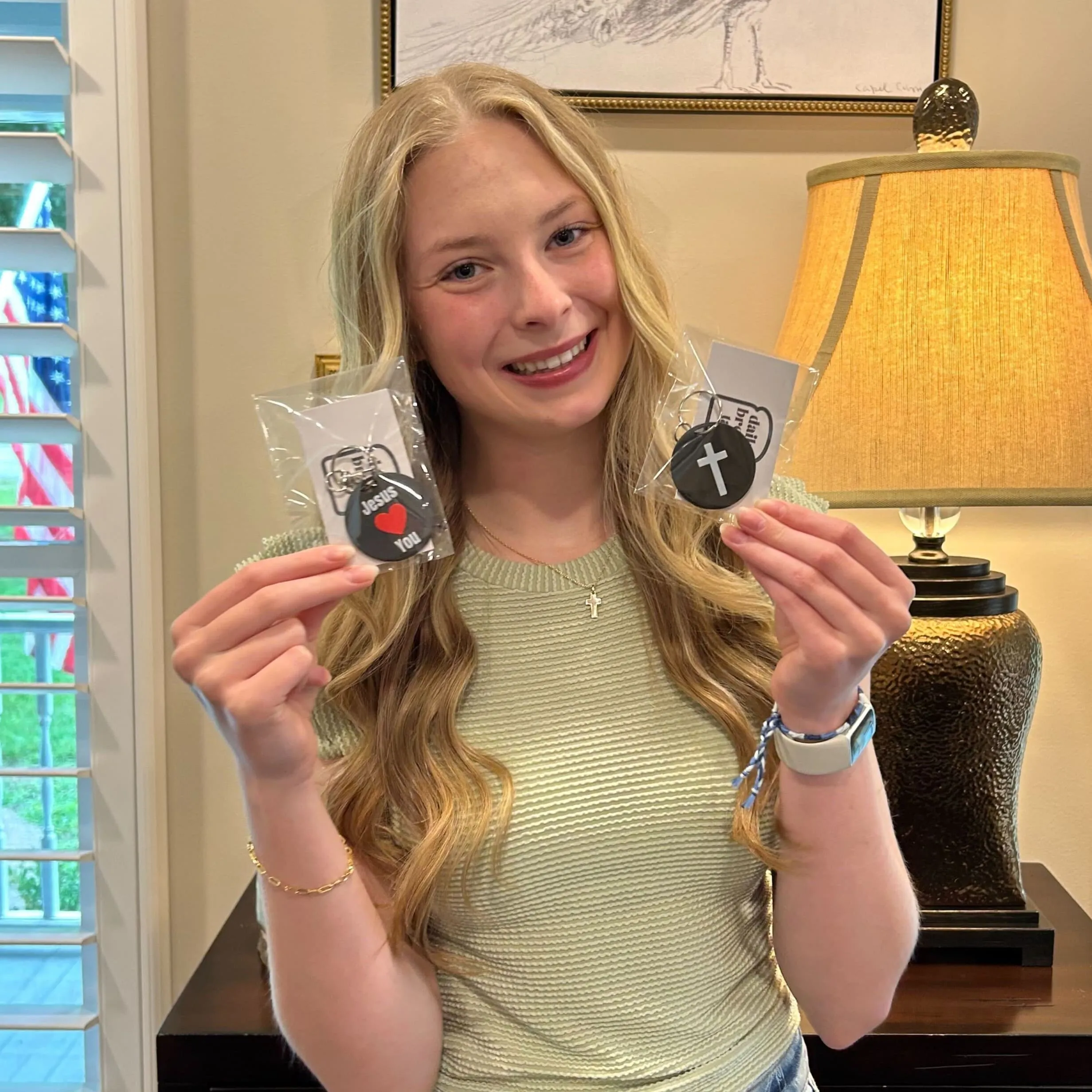 Claire with the keychains she designed and 3D-printed