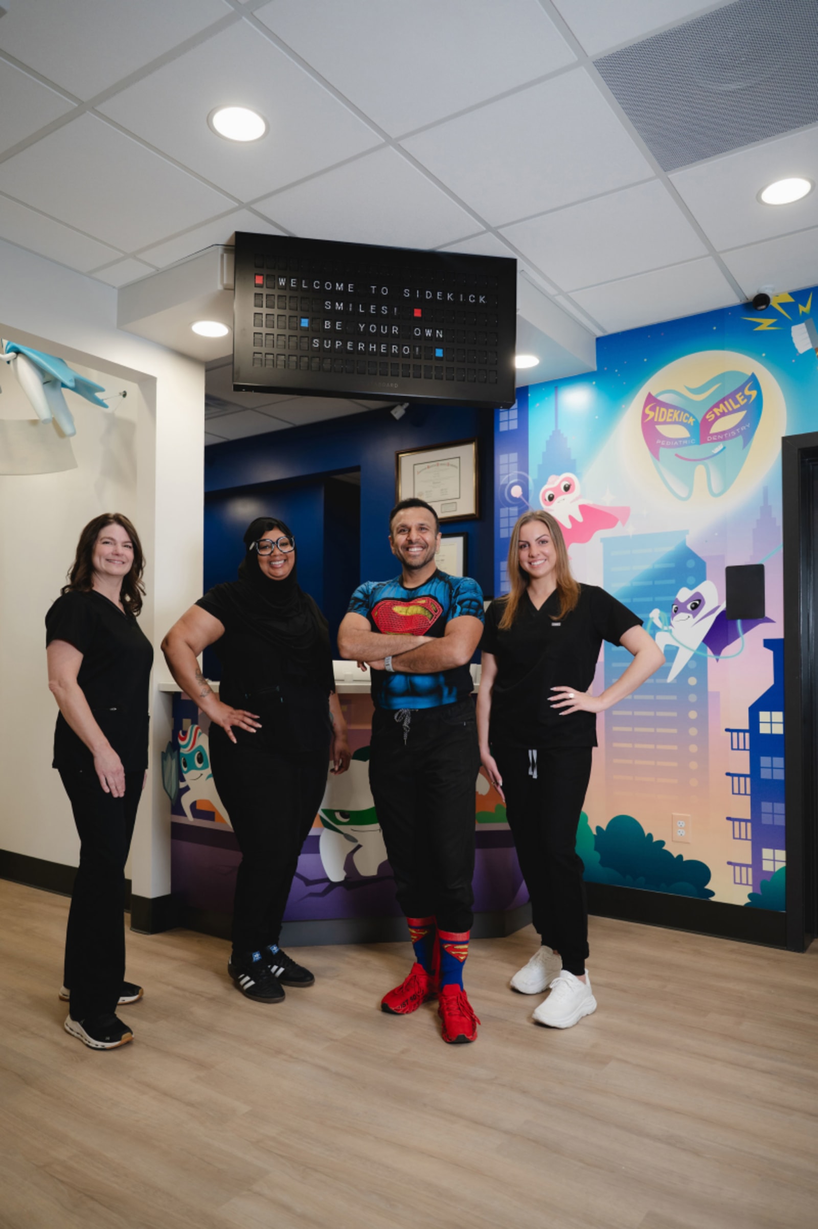 Sidekick Smiles team standing with young patients in the dental practice office