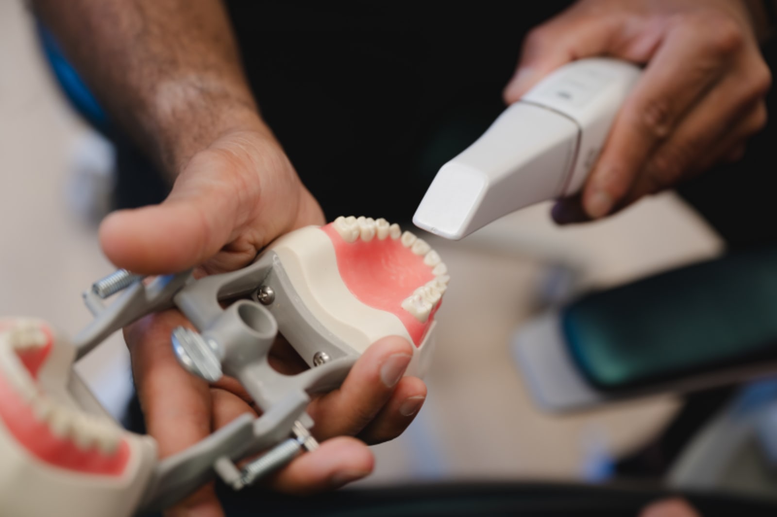 Close-up view of dental cleaning tools being used on a patient's mouth