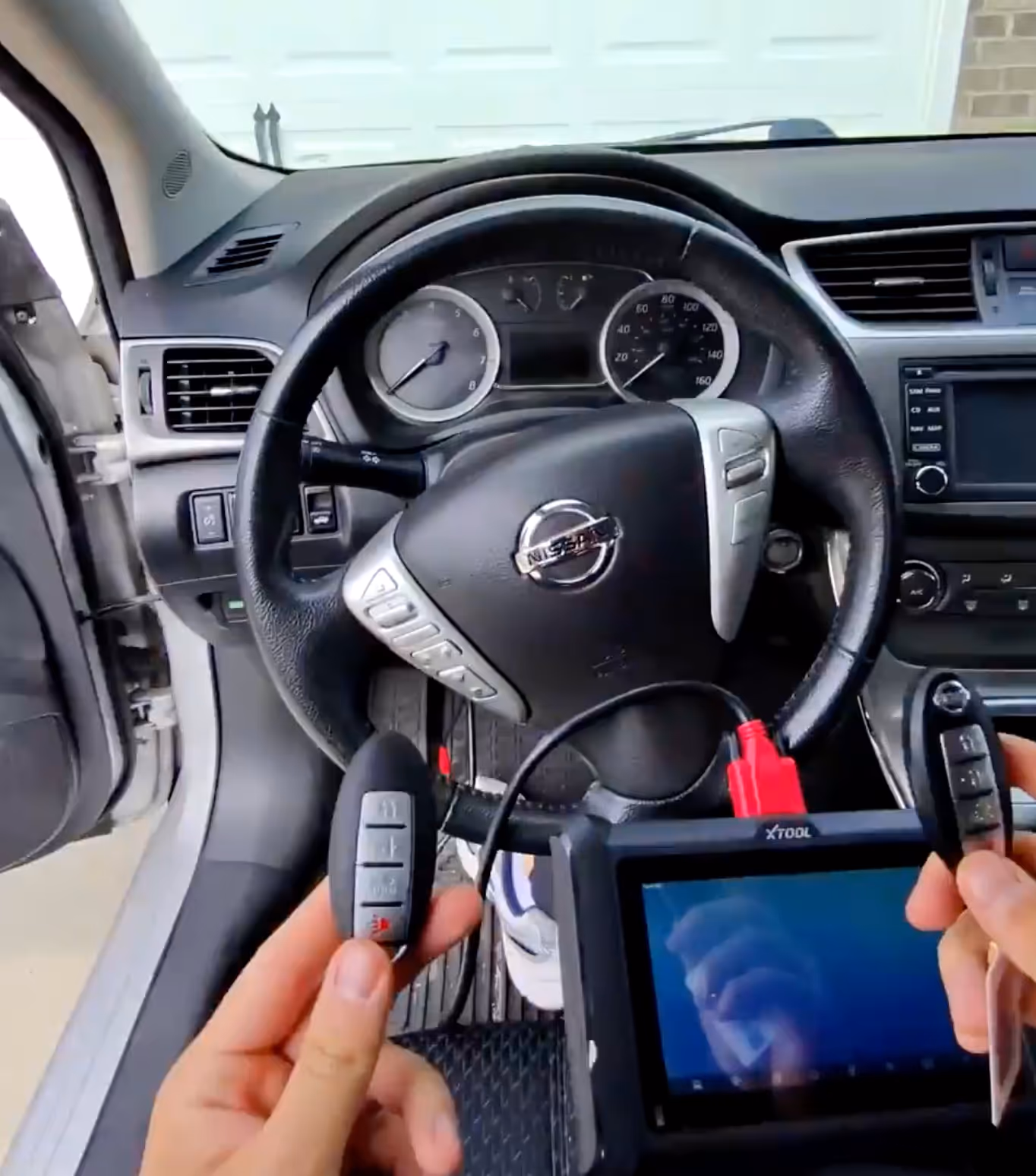 Locksmith making a new chip key for a Nissan Sentra in Fishers, IN