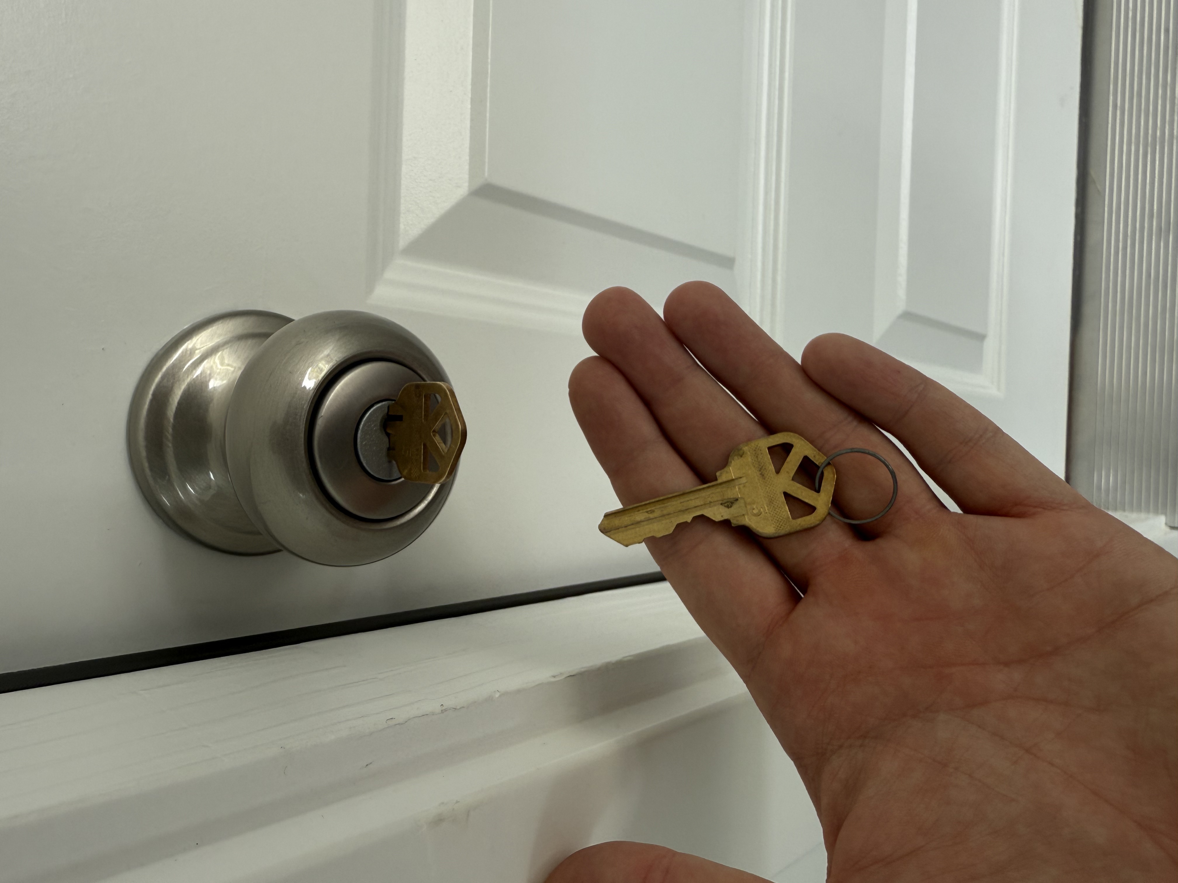 Residential locksmith performing lock rekeying and deadbolt installation on a home in Carmel, Indiana, to improve security and safety