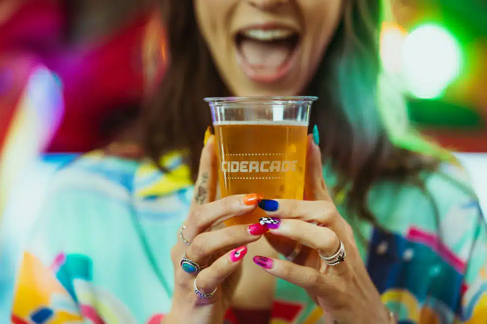 Jewish young adult with Cicerade cup of beer.