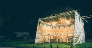 Sukkah against the background of an evening sky.